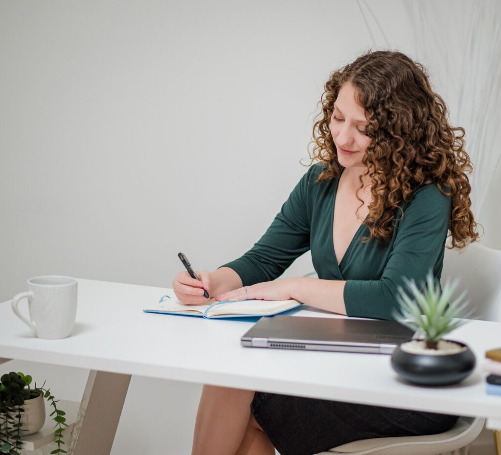 Morgaine Griffin writing at desk